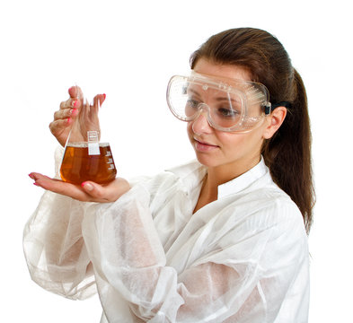 Female scientist in lab coat with chemical glassware.