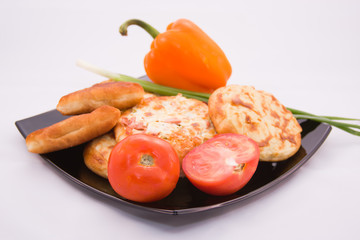 baking on a large platter with ripe tomatoes and green onions on