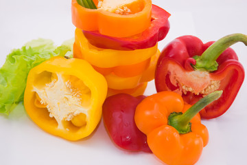 Bulgarian sweet pepper and green leaves of lettuce with a bow on