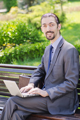 Fototapeta premium Young businessman on the street