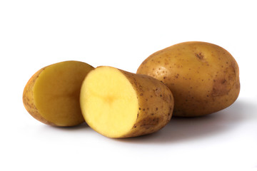 two halves of potatoes and one whole isolated on white