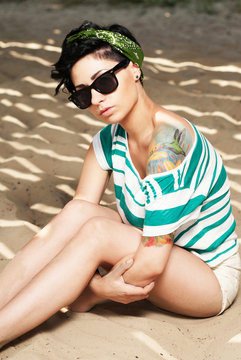 adorable girl with tattoo wearing sunglasses