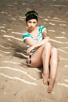 adorable girl with tattoo on the beach