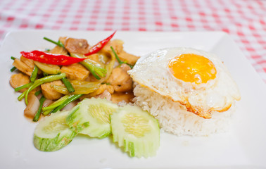 sunny-side up egg on rice with spicy fried vegetable and tofu