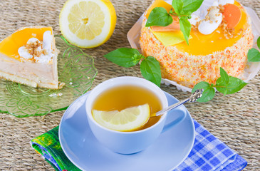 a delicious sweet cake is beautifully decorated and cup of tea w