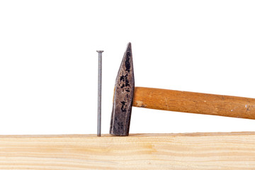 Hammer and nail with wooden board