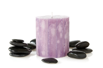 aromatic candle and black pebbles