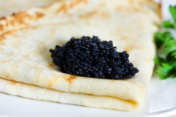 Pancake with black caviar