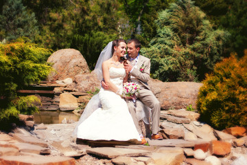 Bride and groom posing in park