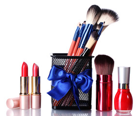 make-up brushes in holder and cosmetics isolated on white