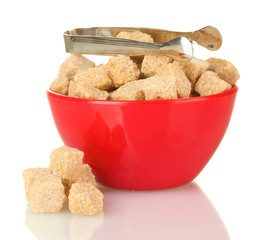 brown cane sugar cubes in bowl with sugar-tongs isolated
