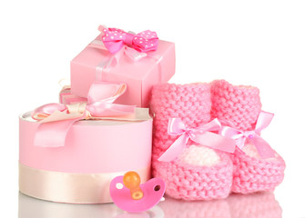 pink baby boots,  pacifier and gifts isolated on white