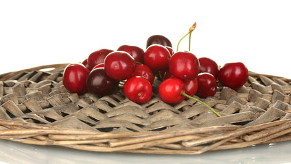 Cherry on the wicker cradle on white background close-up