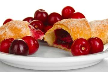 white plate with croissant and cherry