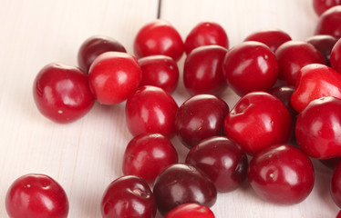 fresh cherry on white wooden table close-up