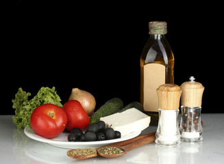 Ingredients for a Greek salad on black background