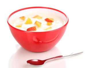 Yoghurt with peach in bowl isolated on white