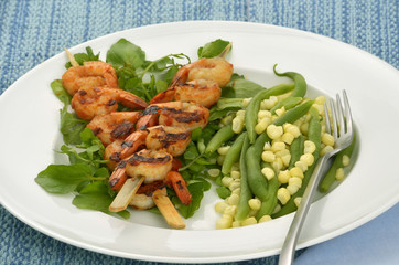 Spicy shrimp skewers with beans and corn