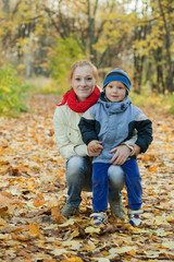 mother with boy in autumn park