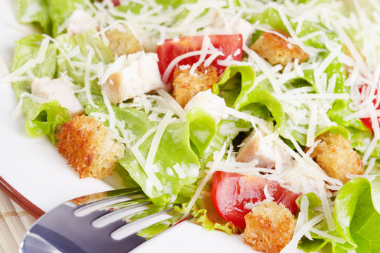 The Caesar salad with chicken and tomatoes