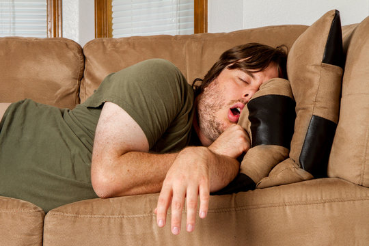 Man taking a quick nap on the couch
