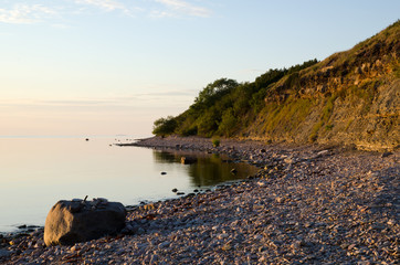 Calm summer evening at a bay with deep steep