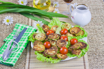 baked vegetable marrows with tomatoes and green sheet lettuce