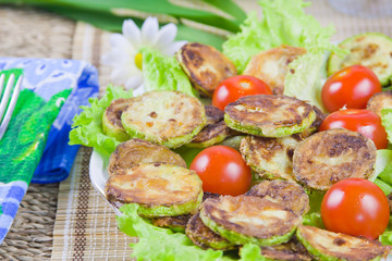 baked vegetable marrows with tomatoes and green sheet lettuce