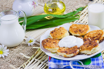 fried curd pancakes on a dish and milk