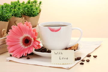 cup of coffee with lipstick mark and gerbera beans, cinnamon