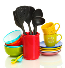 bright empty bowls, cups and kitchen utensils isolated on white