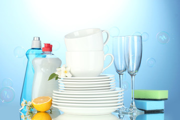 empty clean plates, glasses and cups with dishwashing liquid,