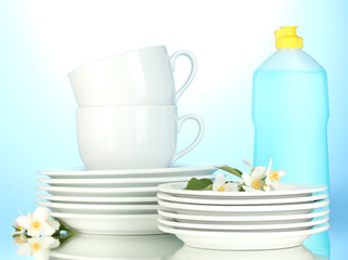 empty clean plates, cups and glasses with dishwashing liquid