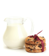 jar of milk and chocolate chips cookies with red ribbon