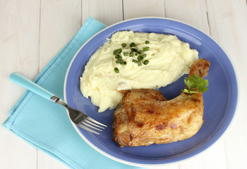roasted chicken leg with mashed potato in the plate