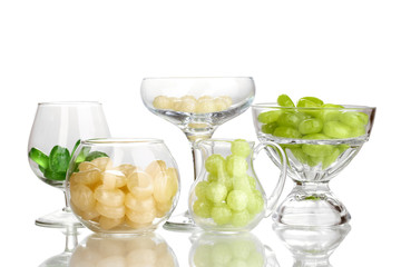 Color candies in glasses isolated on white