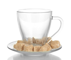 Lump brown cane sugar cubes in glass cup isolated on white