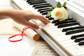hand of woman playing synthesizer