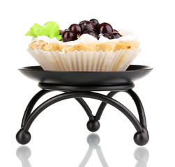 sweet cake with berries on saucer isolated on white