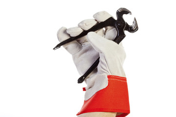 Hand with protection glove holding pincer