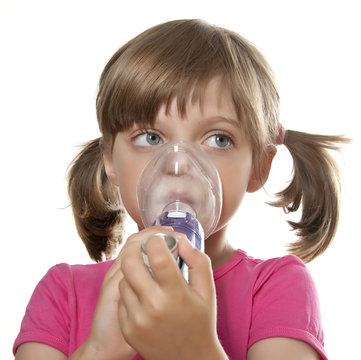 ill little girl using inhaler - respiratory problems