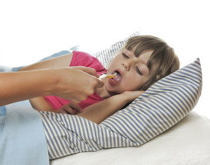 Obraz na płótnie Canvas ill little girl taking cough syrup