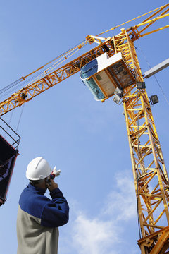 Building Engineer Directing Large Construction Crane