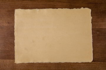 Sheet of handmade paper on wooden table