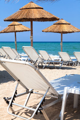 Beautiful beach with deck chairs and umbrellas