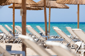 Beautiful beach with deck chairs and umbrellas