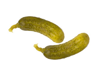 two fresh dill pickles on a white background