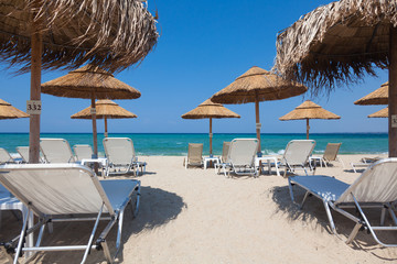 Beautiful beach with deck chairs and umbrellas