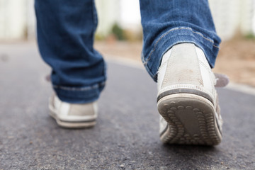 Walking in sport shoes on pavement - 43223055