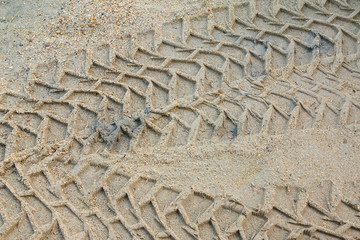 Fototapeta na wymiar Wheel tracks on the sand.